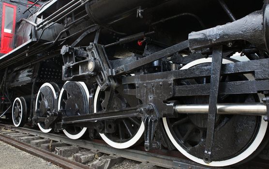 Old Black Steam Locomotive Train with closeup of wheels and boiler