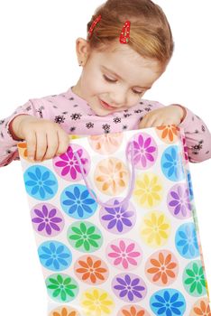 Curious little girl looking in shopping bag
