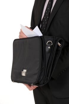 Man removing document from briefcase