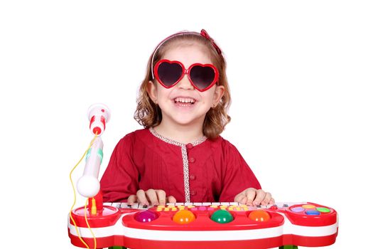 happy little girl with sunglasses play music