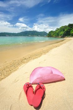 Beautiful beach landscape with hat and flip-flops in Thailand