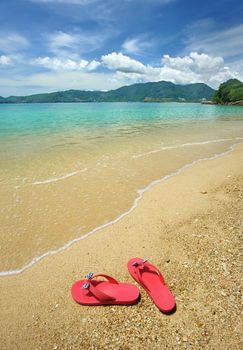 Beautiful beach landscape with flip-flops in Thailand