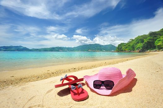 Beautiful beach landscape with hat and flip-flops in Thailand