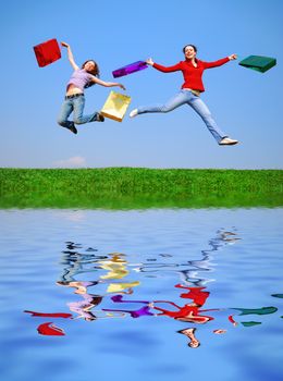 Girls jumping with bags against blue sky with reflection on water