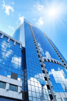 Modern office building with sky reflection in windows