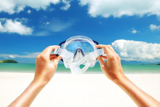 Snorkel equipment against beach and sky