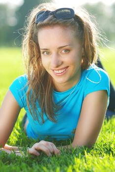 Girl laying on fresh green grass