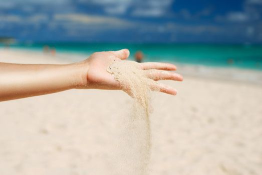 Coral white sand strewing from hand