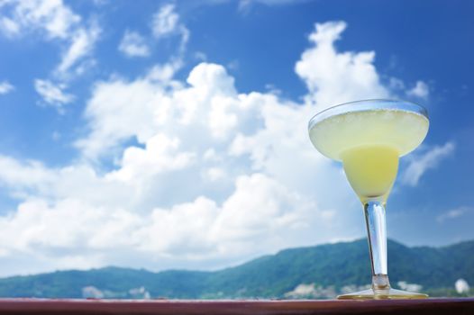 Margarita cocktail with sea and sky in background