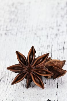 Star Anise spice over a white wooden background. Copyspace available.