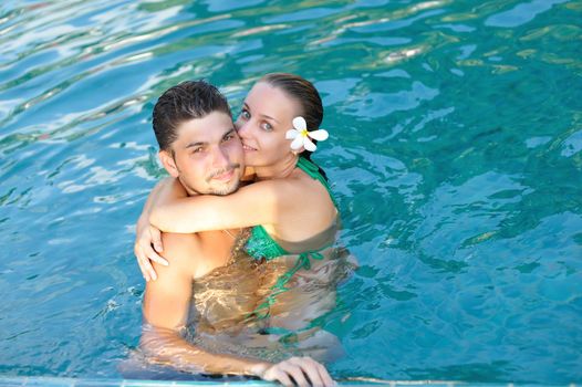 Couple in tropical swimming pool