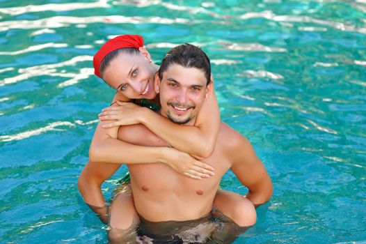 Couple in tropical swimming pool