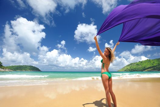 Woman with sarong on beautiful beach