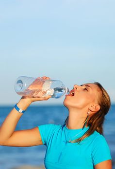 Woman drinking water after jogging