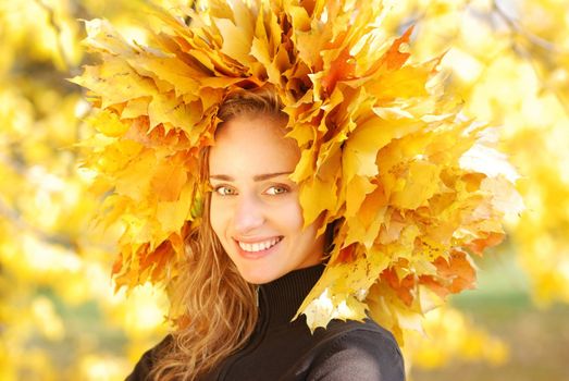 Girl with yellow autumn leaves