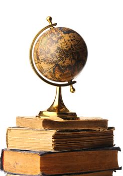 Antique globe on old books isolated over white