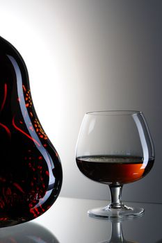 Cognac bottle and glass still life