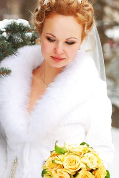 Bride holding bouquet of yellow roses