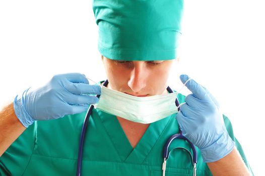 Doctor pulling on surgical mask