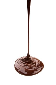 Melted chocolate flowing on chocolate plates isolated on white background