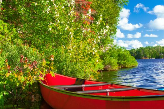 Red canoe on a lake. 