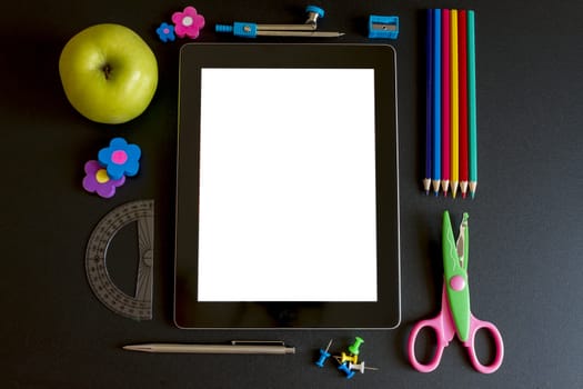 Tablet PC with school accesories on white background