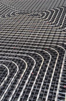 Black underfloor heating posed in a underconstruction building