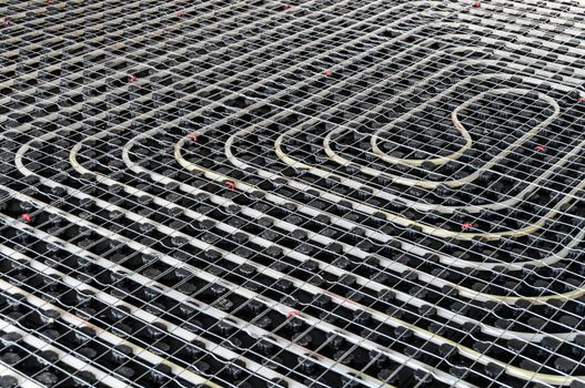 Black underfloor heating posed in a underconstruction building