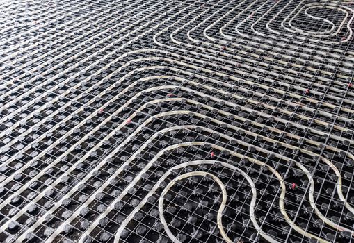 Black underfloor heating posed in a underconstruction building