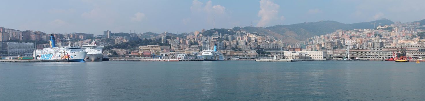 Panorama of ferries docked in the port of Genoa. This photo is made attaching together various photos
