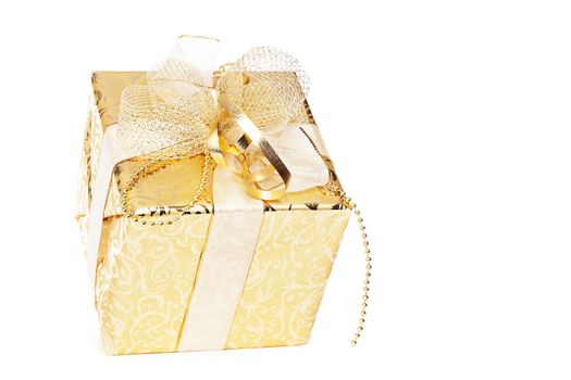 golden christmas present with golden ribbons on white background