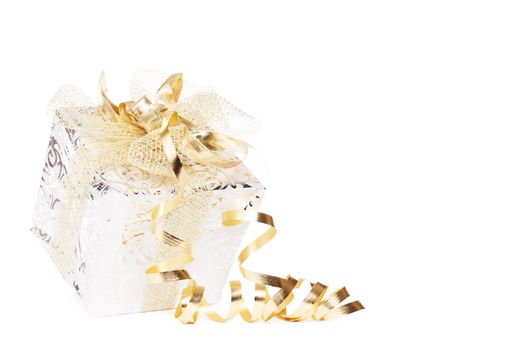 beautiful silver christmas present with golden ribbons and streamer on white background