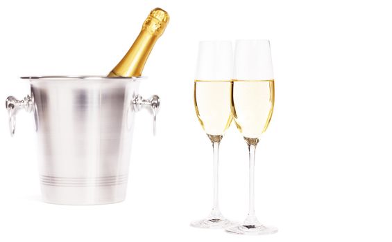 two glasses of champagne with a champagne bottle in a bucket on white background