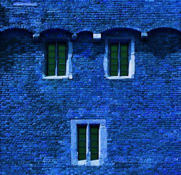 background or texture of a blue brick wall with windows