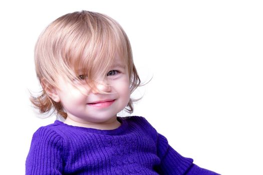 Little girl is smiling through her long never cut messy hair. Isolated on white background.