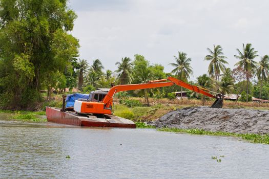 backhoe in the pontoon, working in the canal, Thailand