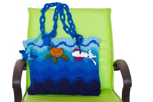 Handmade crochet knitting bag and green chair