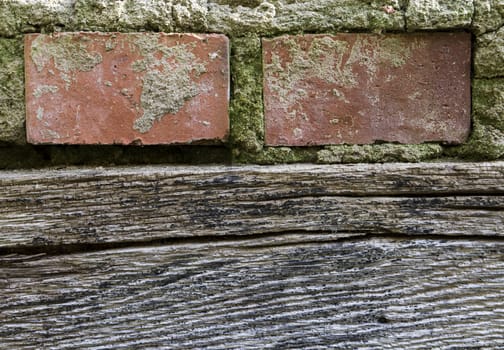detail of old wall with wooden beam and two bricks