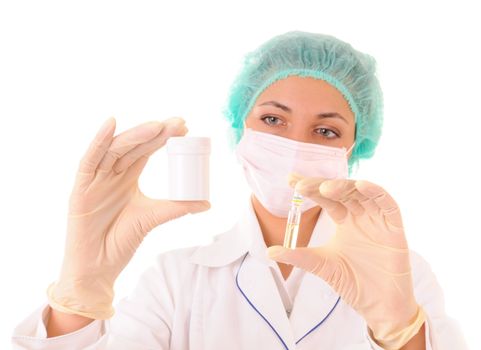 Woman in medical workwear with bottle and ampule with medicines in hands. Isolated on white background. Focus on hands.