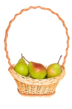 Ripe organic pears in handmade basket isolated on white background