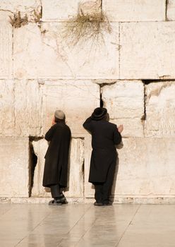 Two praying jews near Jerusalem wall