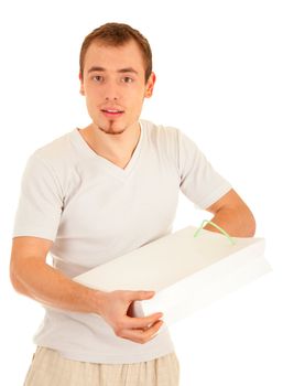 Interested handsome man is checking inside white gift paper bag. Isolated on white background.