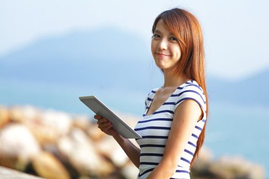 young asian woman with tablet outdoor