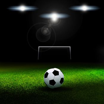 Soccer ball on grass against black background