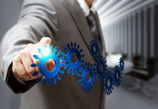 business man hand point cogs icons in board room
