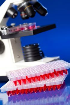 96 well plates on lab table with red liquid samples