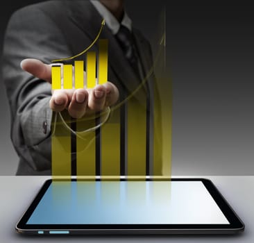 business man hand shows virtual gold graph with tablet computer