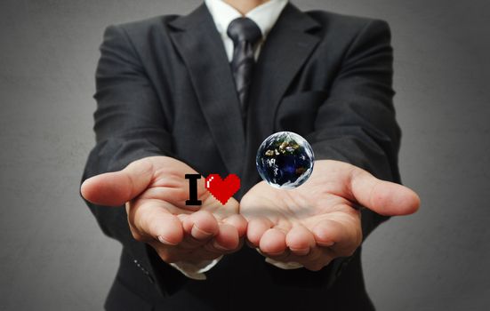 business man hand holds I love the earth as concept, elements of this image furnished by NASA