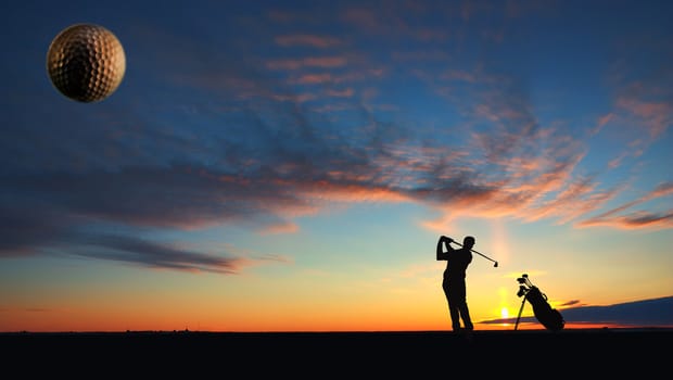 A man playing golf on sunset