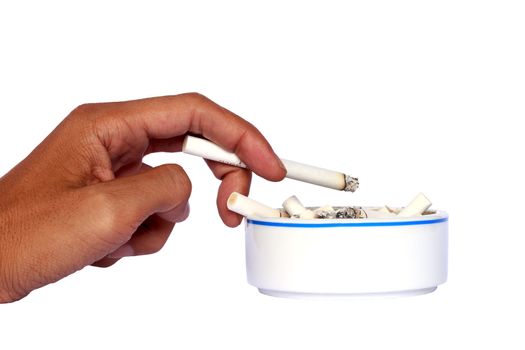 Isolated hand and ceramic ashtray with cigarettes.